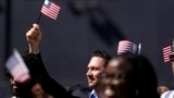 FILE - A man, part of a group of 50 new United States citizens, takes part in a naturalization ceremony before the San Diego Padres host the Minnesota Twins in a baseball game at Petco Park, Wednesday, Aug. 21, 2024, in San Diego. (AP Photo/Gregory Bull)