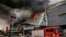Firemen battle a fire that rages at a shopping mall, Dec. 23, 2017, in Davao city, southern Philippines. 