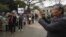 FILE - Nguyen Quang A films an anti-China protest in Hanoi, Vietnam, Feb. 17, 2016. Quang A is looking to be elected to Vietnam's parliament.