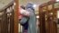 This file photo taken on February 19, 2018, shows French Jihadist Melina Boughedir carrying her son as she arrives to court in the Iraqi capital Baghdad.