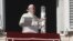 Pope Francis holds a candle decorated with the faces of Syrian children suffering from war during the Angelus noon prayer St. Peter's Square at the Vatican, Dec. 2, 2018. 