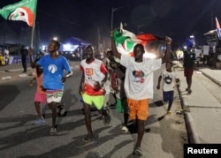 Supporters of Ghana's main opposition National Democratic Congress party candidate and former Ghanian President John Dramani Mahama celebrate after he won in polling stations in the Jamestown neighborhood of Accra, Ghana, Dec. 7, 2024.