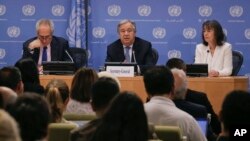 Secretary-General Antonio Guterres, center, accompanied by U.N. spokesman Stephane Dujarric, left, and Ninette Kelley, director of the office of the U.N. High Commissioner for Refugees, speaks to U.N. correspondents on World Refugee Day at U.N. headquarters in New York, June 20, 2017. 