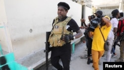 FILE - Former police officer Jimmy 'Barbecue' Cherizier addresses the media, in Port-au-Prince on March 11, 2024. Cherizier is the leader of an alliance of armed gangs in the Haitian capital.