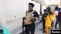 FILE - Gang leader Jimmy "Barbecue" Cherizier talks to reporters in Port-au-Prince, Haiti, March 11, 2024. Armed men working under Cherizier ambushed a police patrol vehicle in the Delmas 18 neighborhood June 9, 2024, and set it on fire, police said. Three officers died.