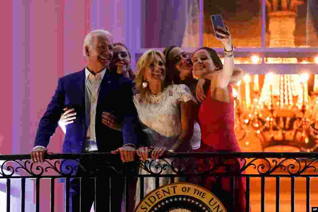 President Joe Biden poses for a photo with granddaughter Finnegan Biden, from left, first lady Jill Biden, granddaughter Naomi Biden and daughter Ashley Biden as they view fireworks during an Independence Day celebration at the White House, Washington.