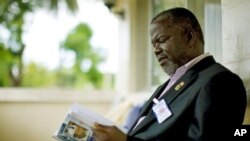 Former Liberian warlord and current senator Prince Johnson reads in his home in Monrovia (June 2009 file photo)