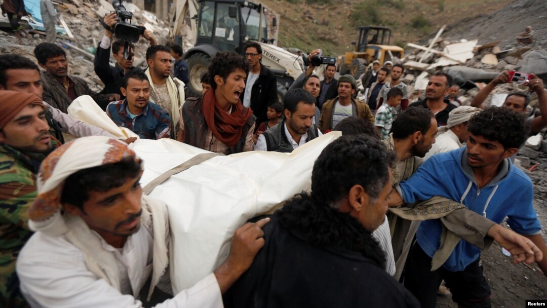 People carry the body of a woman they recovered from under the rubble of a house destroyed by a Saudi-led airstrike in Sanaa, Yemen, Aug. 25, 2017. 