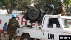 FILE - UN peacekeepers take a break as they patrol along a street in Bangui, the capital of Central African Republic, Dec. 30, 2015. 