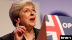 British Prime Minister Theresa May delivers her keynote address on the final day of at the Conservative Party Conference in Birmingham, Oct. 3, 2018.