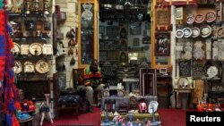 A man waits tourists at a souvenirs shop at the Khan el-Khalili market in Old Cairo, March 17, 2013. 