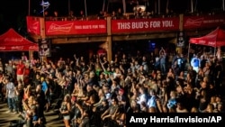 FILE - Fans attend a performance by Saul at the Iron Horse Saloon during the 80th annual Sturgis Motorcycle Rally, in Sturgis, S.D., Aug. 14, 2020. A number of people who attended the rally have come down with COVID-19. 
