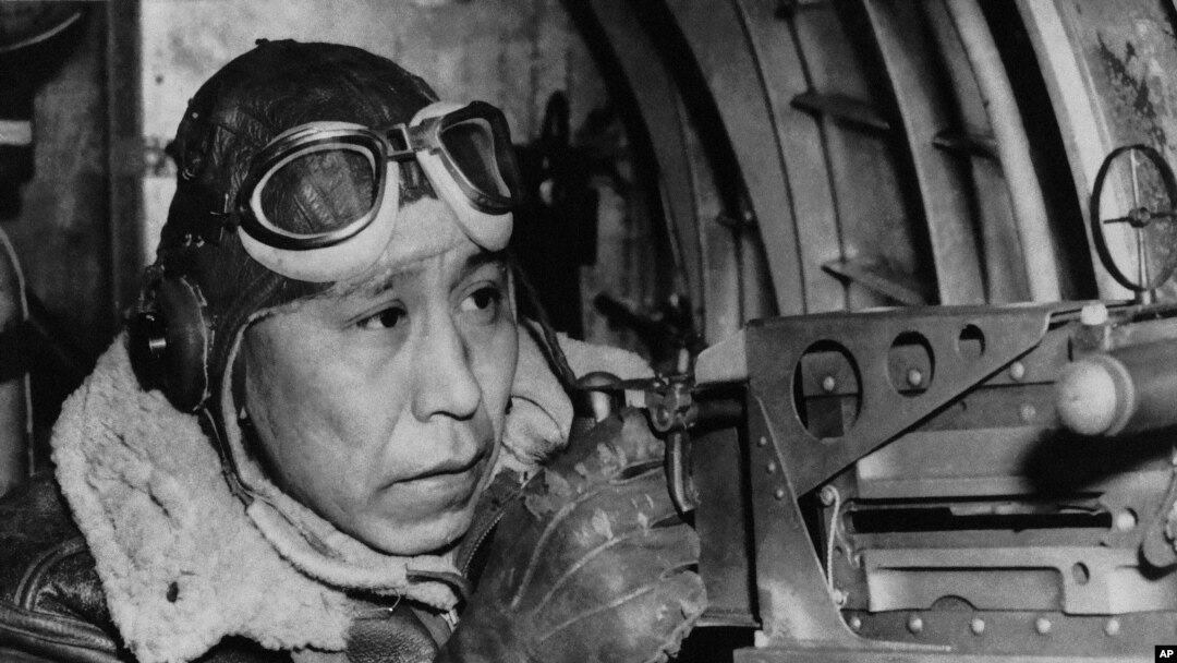 File photo shows Sgt. Gilbert Eagle Feather, Lakota from Rosebud, S.D., at the waist gun of his B-17 Flying Fortress, Dec. 24, 1943. 