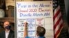 A man tallies the votes from the five ballots cast just after midnight in Dixville Notch, New Hampshire.