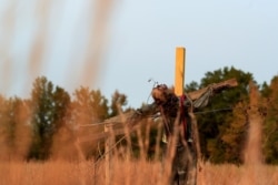 A scarecrow hangs from a cross on the haunted trail of Terror Town, Oct. 17, 2020, in Williamsburg, Ohio.
