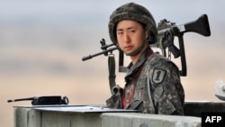 FILE - A South Korean soldier stands on a military guard post near the demilitarized zone (DMZ) dividing the two Koreas in the border city of Paju.