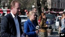 Members of the media report at the area of an explosion in the historic Sultanahmet district of Istanbul, Tuesday, Jan. 12, 2016. 