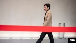 FILE - Hong Kong Chief Executive Carrie Lam arrives for a press conference in Hong Kong, Nov. 19, 2019.