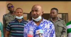 Claude Mboutou Abessolo (talking), the ranking officer at the Nlonkak police station, Yaounde, July 22, 2021. (Moki Edwin Kindzeka/VOA)