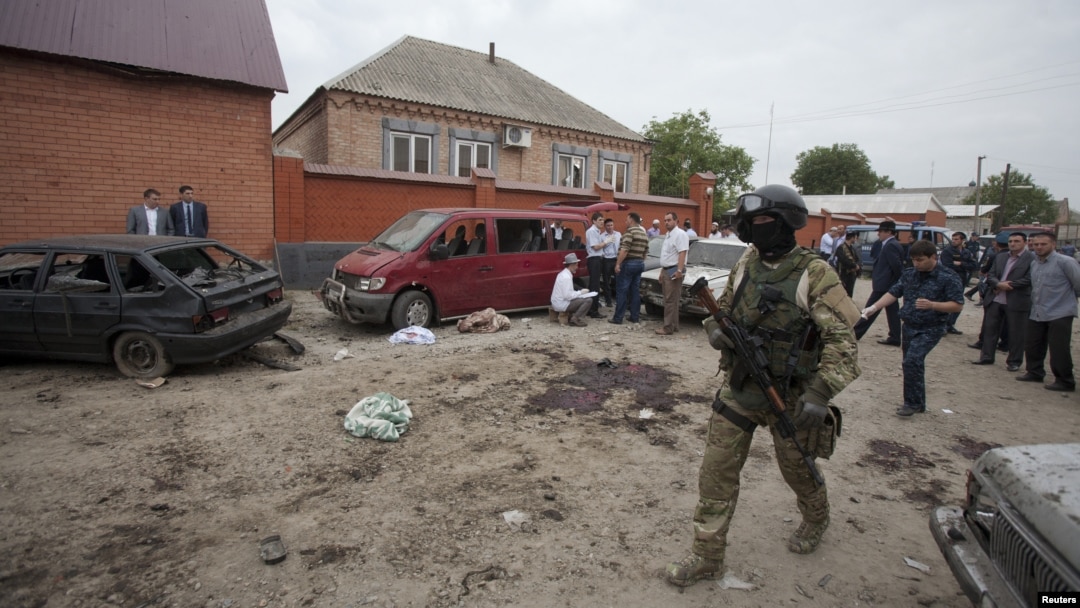 Investigators work at the site of a suicide bomb attack in the Malgobek district in the north of Ingushetia, August 19, 2012.