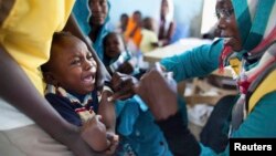 A child receives a meningitis vaccination at the community center in El Daein, East Darfur, Sudan on October 8, 2012. 