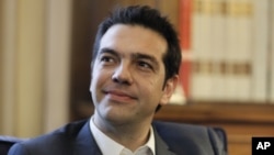 Greek leader of Coalition of the Radical Left party (SYRIZA) Alexis Tsipras looks on during a meeting with Greek President Karolos Papoulias, to formally take the mandate to form a coalition government in Athens. 