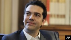 Greek leader of Coalition of the Radical Left party (SYRIZA) Alexis Tsipras looks on during a meeting with Greek President Karolos Papoulias, to formally take the mandate to form a coalition government in Athens. 