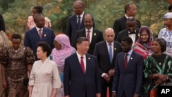 China's President Xi Jinping and his wife, Peng Liyuan, get ready to pose for a group photo with leaders from African countries at the Forum on China-Africa Cooperation in the Great Hall of the People in Beijing, Sept. 4, 2024. 