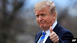 FILE - President Donald Trump gestures to the media.