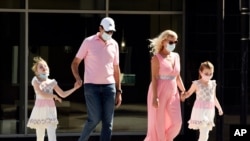 Pedestrians wear masks as they cross Brand Boulevard, Thursday, July 23, 2020, in Glendale, Calif. Three out of four Americans, including a majority of Republicans, favor requiring people to wear face coverings while outside their homes, a new poll…