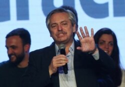 FILE - Presidential candidate Alberto Fernandez speaks during the primary elections, at a cultural center in Buenos Aires, Argentina, Aug. 11, 2019.