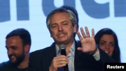 FILE - Presidential candidate Alberto Fernandez speaks during the primary elections, at a cultural center in Buenos Aires, Argentina, Aug. 11, 2019.