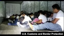 This photo released by U.S. Customs and Border Protection shows people they discovered inside a tractor-trailer at a U.S. Border Patrol checkpoint in Laredo, Texas. 