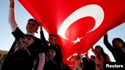 Youth are seen in Ankara holding Turkey's national flag and wearing T-shirts adorned with the image of Mustafa Kemal Ataturk, secular Turkey's founder (file photo).