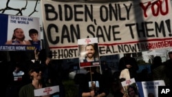 FILE -Families of Israeli hostages held by Hamas in Gaza hold signs and photos of their loved ones at a protest calling for their return, outside a meeting between U.S. Secretary of State Antony Blinken and Israeli President Isaac Herzog, in Tel Aviv, Israel, January 9, 2024.