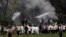 Cuba's President Miguel Diaz-Canel, third from left, walks away from the site where a Boeing 737 plummeted into a yuca field with more than 100 passengers on board, in Havana, May 18, 2018. 