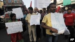 People hold placards as they campaign against nuclear power plants in Mumbai, India, April 26, 2012.