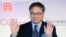 China Mobile Chief Executive Li Yue waves to the press during a ceremony in Taipei linking the first undersea fiber optic cable between Taiwan and China on January 18, 2013. 