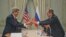 U.S. Secretary of State John Kerry (L) gives a pair of Idaho potatoes as a gift to Russia's Foreign Minister Sergei Lavrov at the start of their meeting at the U.S. Ambassador's residence in Paris, France.