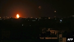 Flames are seen after an Israeli air strike in the town of Khan Yunis, in the southern Gaza Strip, early Oct. 23, 2020. 