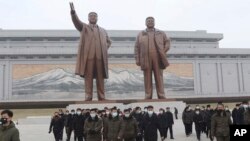 North Koreans visit and pay respect to the statues of late leaders Kim Il Sung and Kim Jong Il on Mansu Hill in Pyongyang, North Korea, Jan. 22, 2023 on the occasion of the Lunar New Year. 