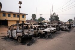 Burned vehicles are parked outside the police command headquarters in Owerri, Nigeria, on April 5, 2021.