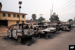 Burned vehicles are parked outside the police command headquarters in Owerri, Nigeria, on April 5, 2021.