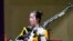 Yang Qian, of China, reacts after winning the gold medal in the women's 10-meter air rifle at the Asaka Shooting Range in the 2020 Summer Olympics, July 24, 2021, in Tokyo, Japan. 