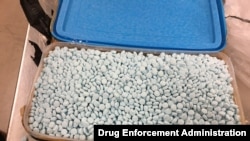 FILE - This photo provided by the U.S. Drug Enforcement Administration's Phoenix Division shows one of four containers holding some of the 30,000 fentanyl pills the agency seized in Tempe, Ariz., in August 2017. 