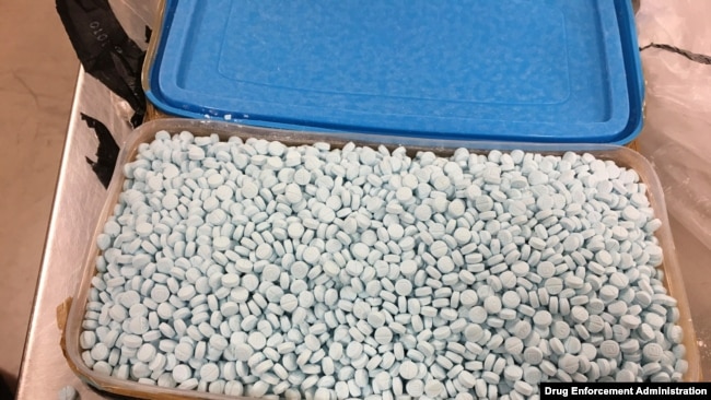 FILE - This photo provided by the U.S. Drug Enforcement Administration's Phoenix Division shows one of four containers holding some of the 30,000 fentanyl pills the agency seized in Tempe, Ariz., in August 2017.
