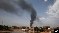 FILE - Smoke rises over Khartoum, Sudan, on June 8, 2023, as fighting between the Sudanese army and paramilitary Rapid Support Forces continues. More than 20 people were killed on Nov. 5, 2023, after shells hit a market in a suburb of Khartoum.