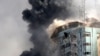 The building housing the offices of The Associated Press and other media in Gaza City collapses after it was hit by an Israeli airstrike May 15, 2021.