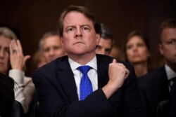 FILE - White House Counsel Don McGahn listens to Supreme Court nominee Brett Kavanaugh as he testifies before the U.S. Senate Judiciary Committee on Capitol Hill in Washington, Sept. 27, 2018.