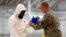 Miembros del Ejército de EE.UU., ayudan al personal médico a combatir el brote de Ébola, en Liberia.